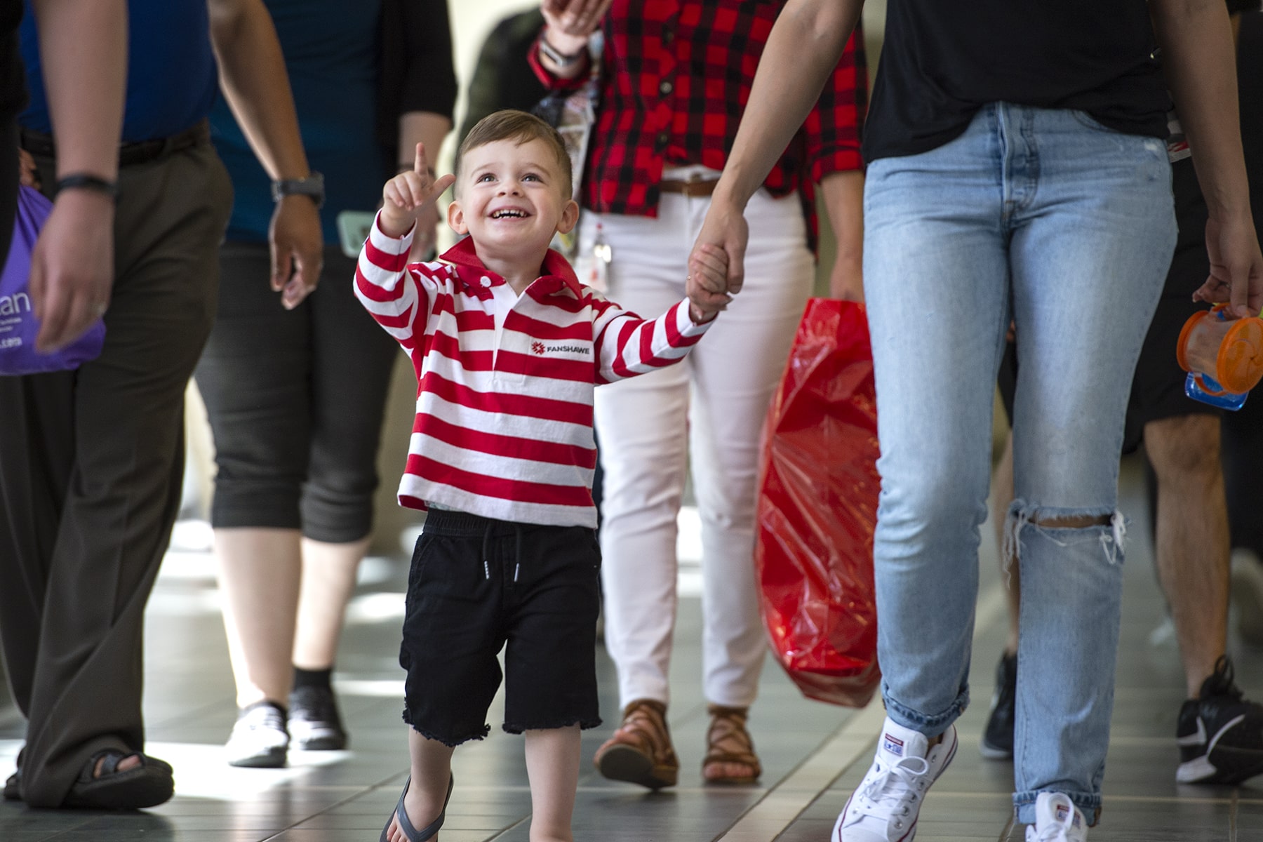 child pointing upwards and smiling