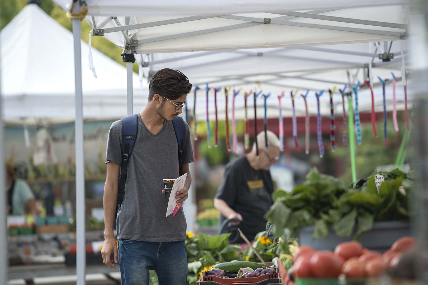 man looking at shelf of groceries