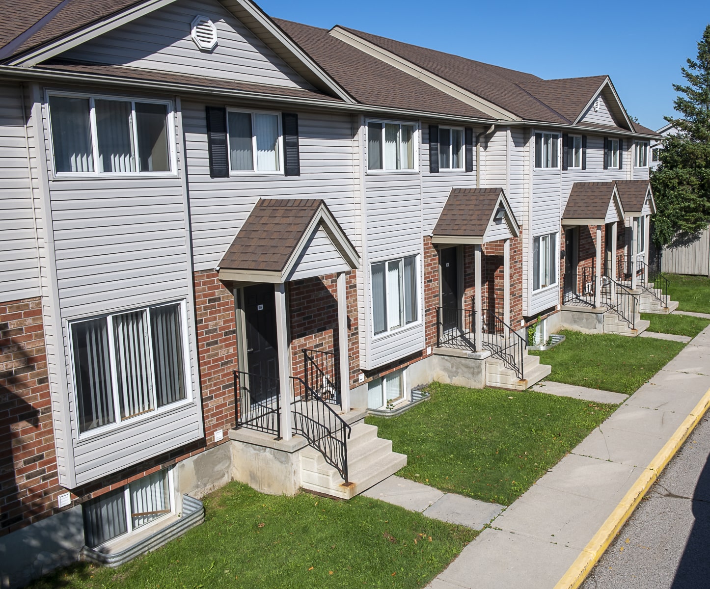 townhouses' front steps and manicured lawns