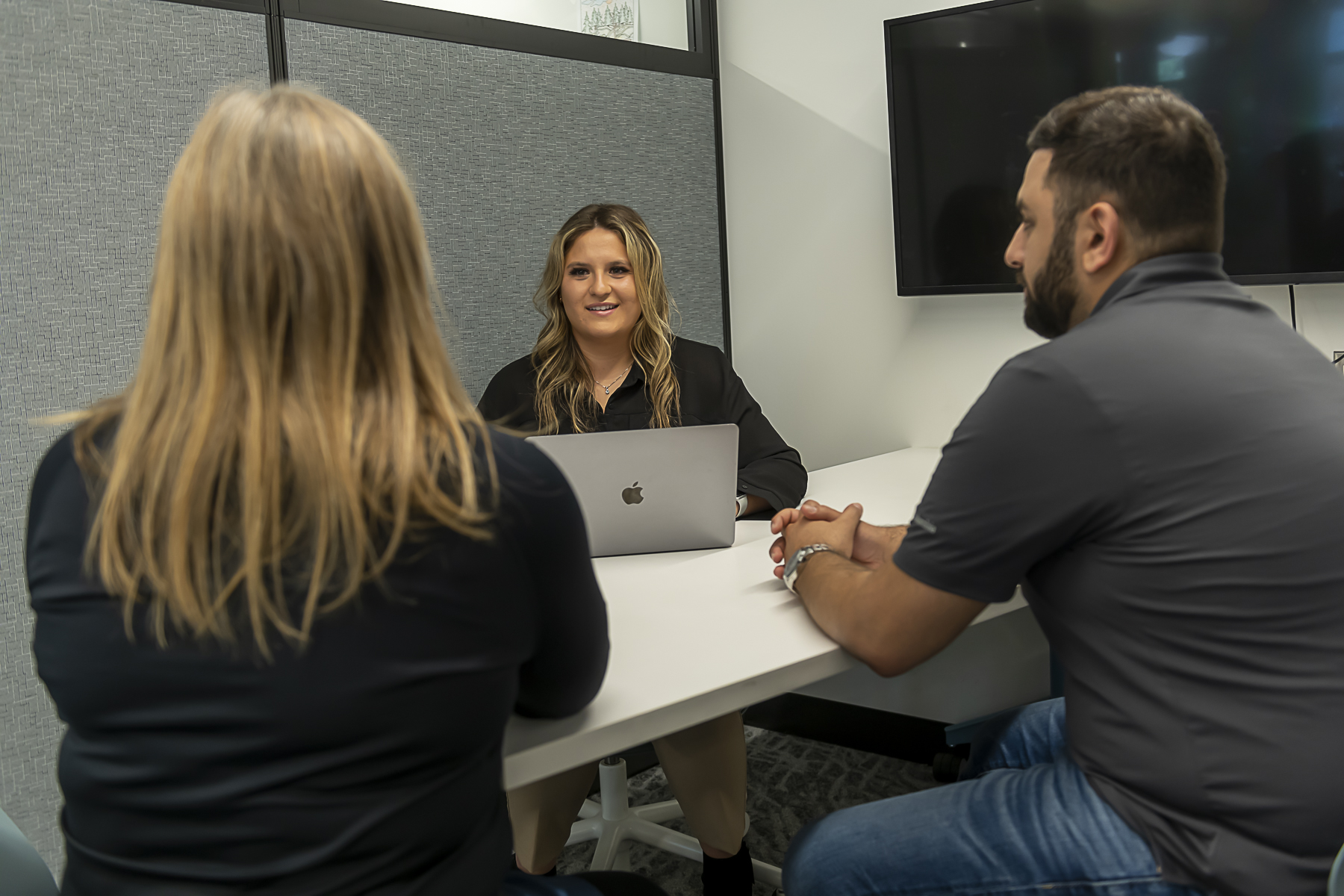 A female HR student practicing interview skills with two other Fanshawe students