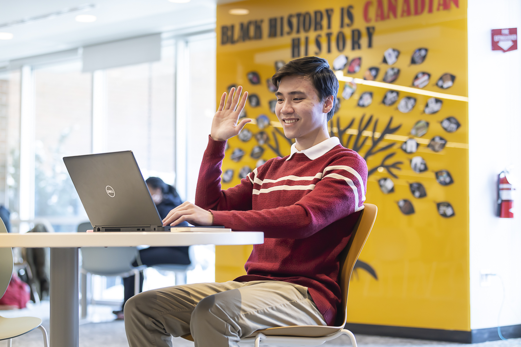 A male HR student getting ready to practice a virtual interview on his laptop.