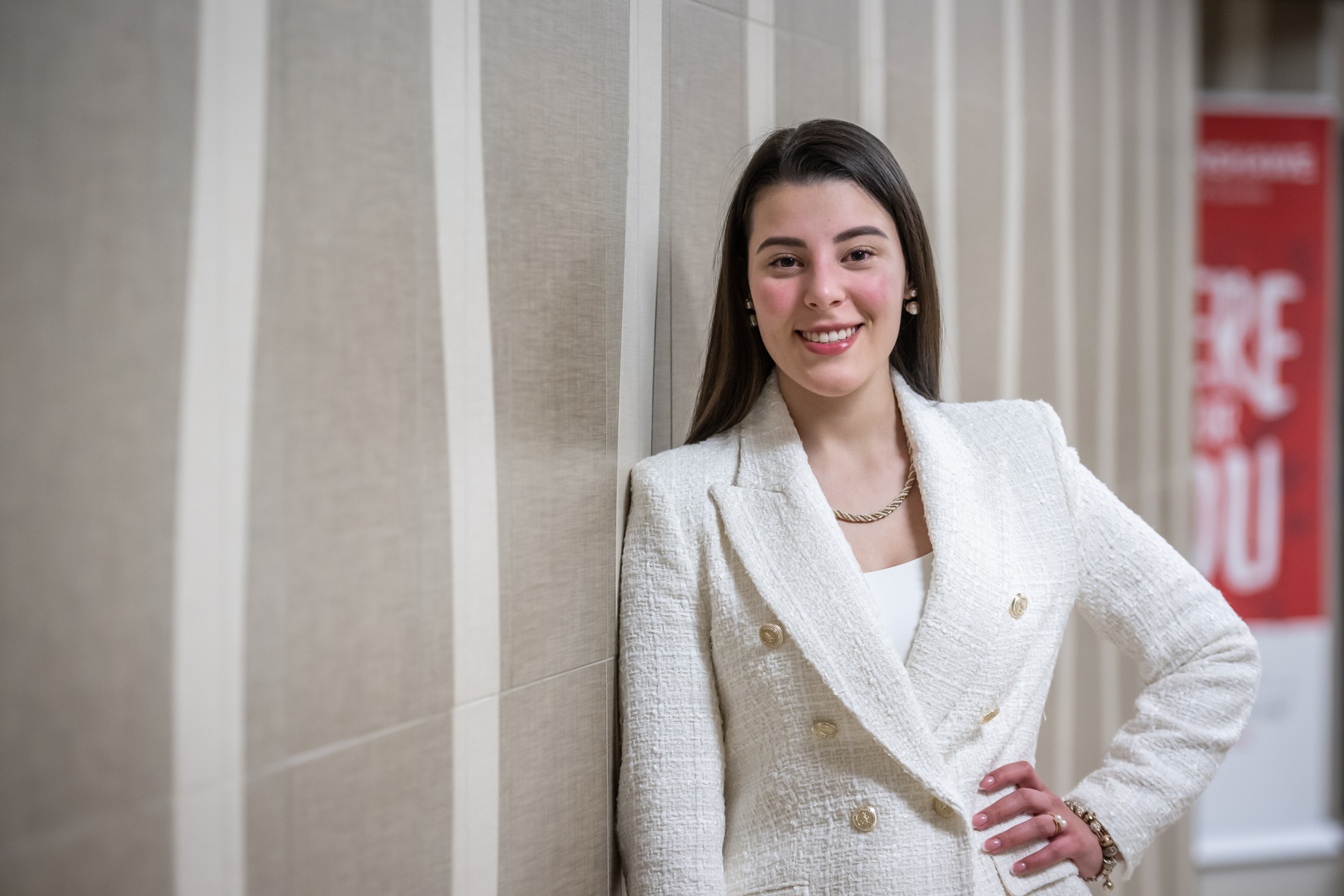A female accounting student smiling and posing for a picture in a hallway on the Fanshawe College campus.