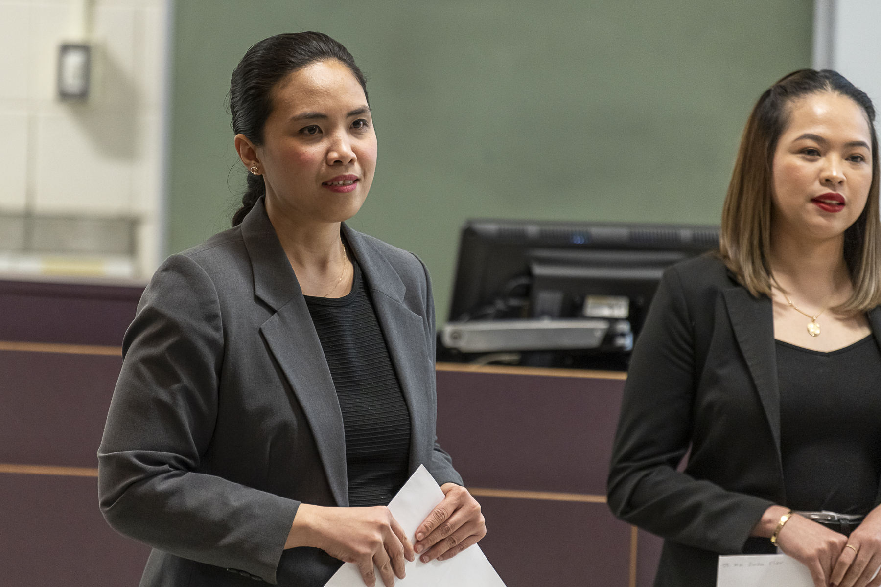 Two female student presenting their Operations projects to their class.