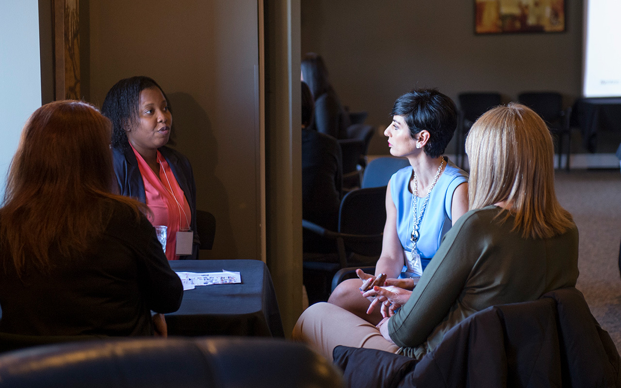 Photo of industry professionals having a discussion at a table
