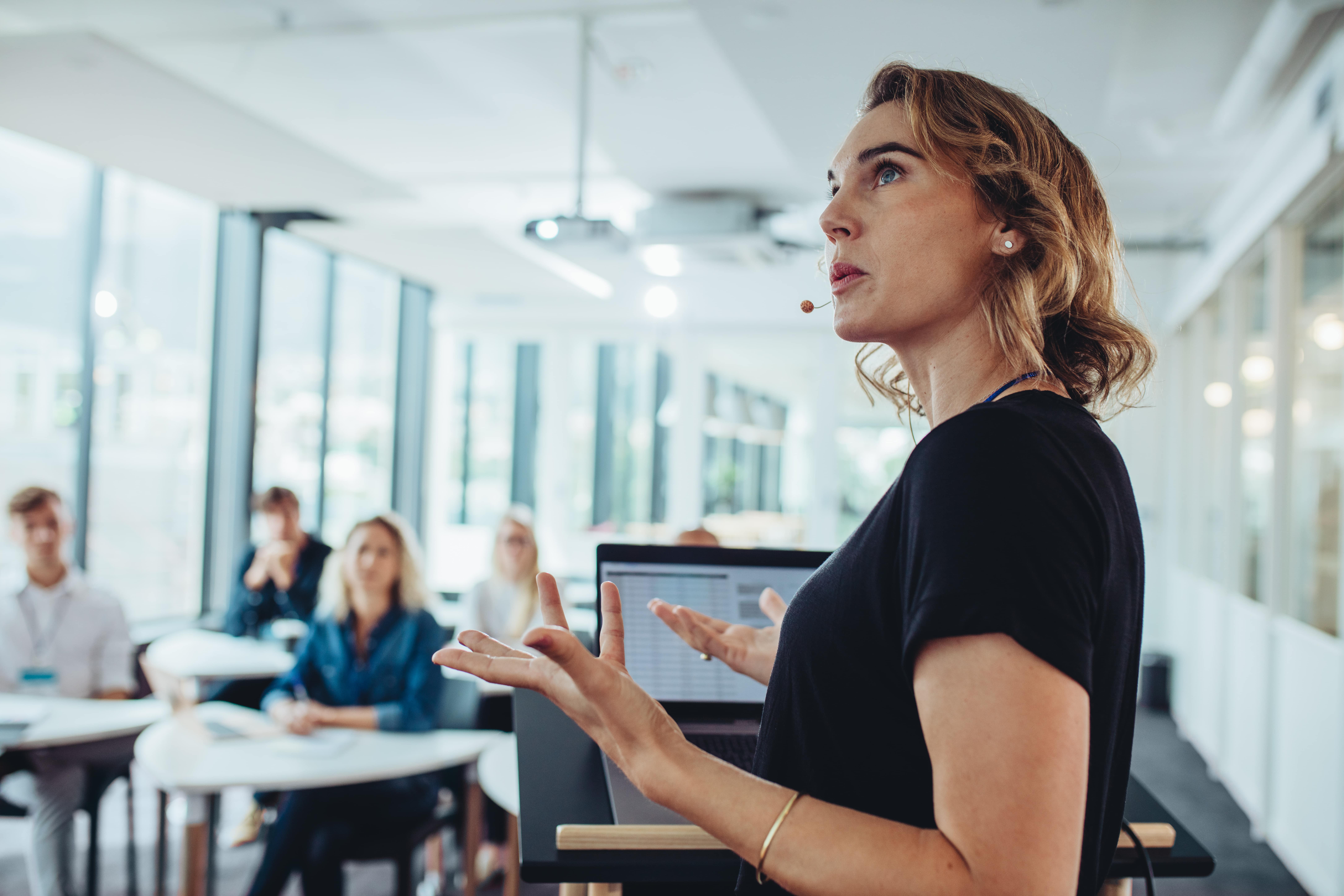 woman standing in front of a group, speaking