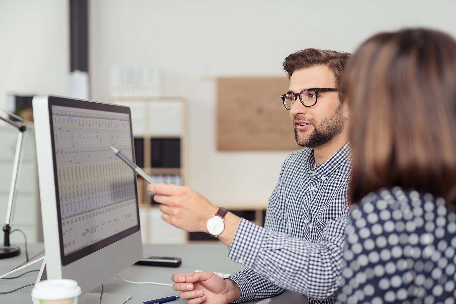 Researchers reviewing data on a spreadsheet