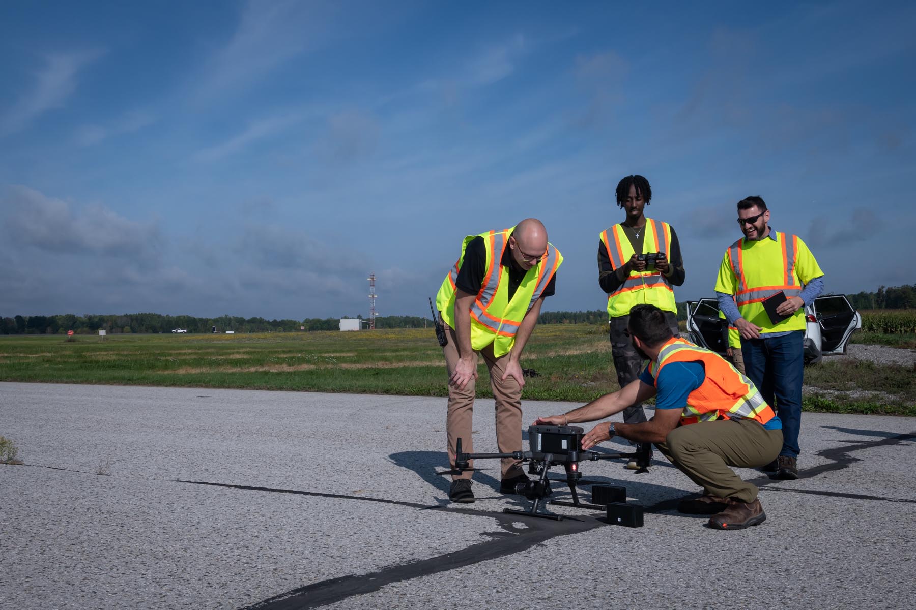 Students setting up a drone on the runway