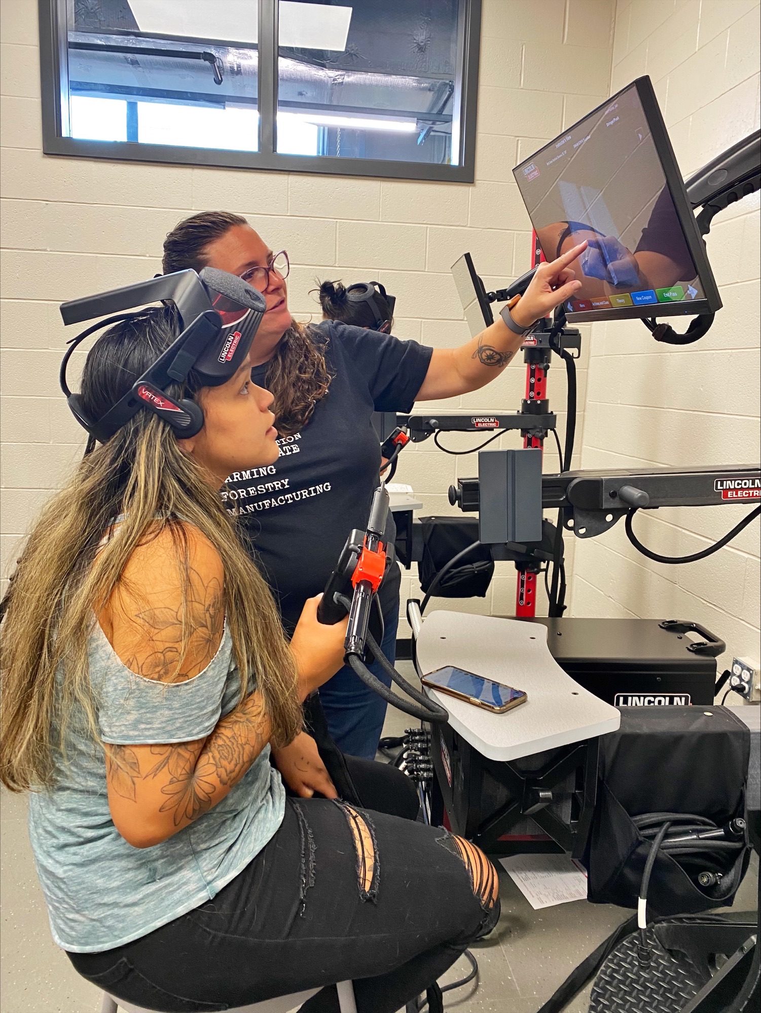 Women of steel participant working on an AI welding machine