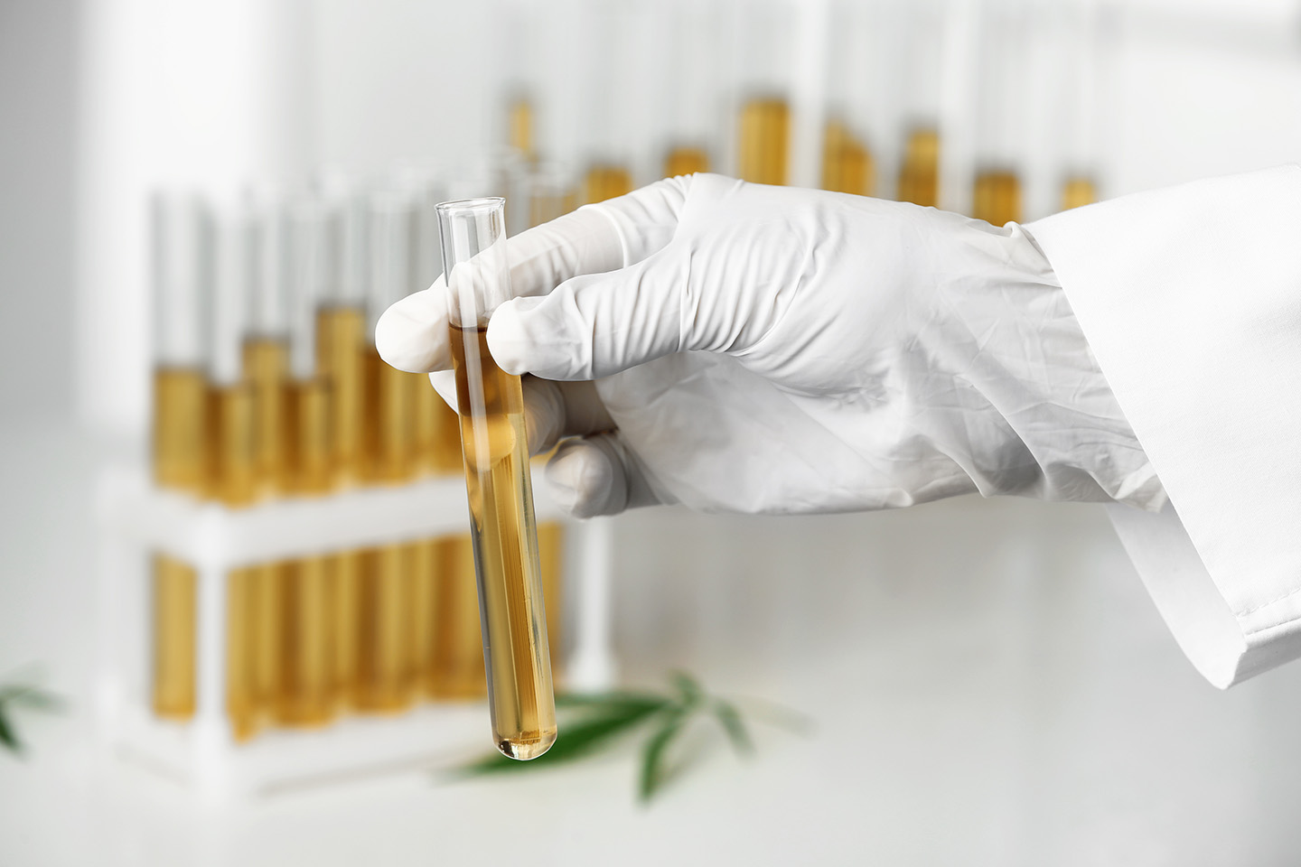 Photo of a researcher holding a vial
