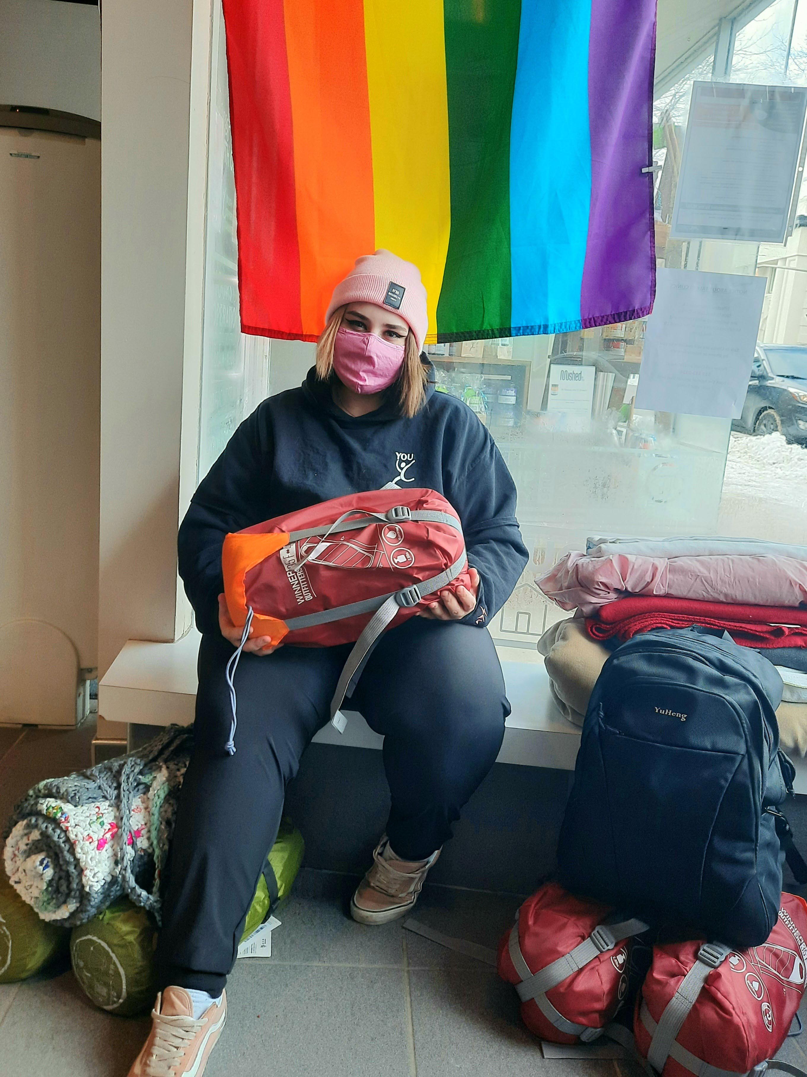 Photo of youth holding a new backpack