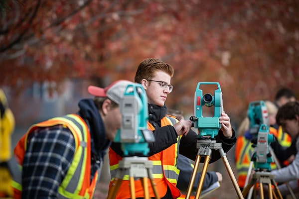 Civil engineering students perform surveys