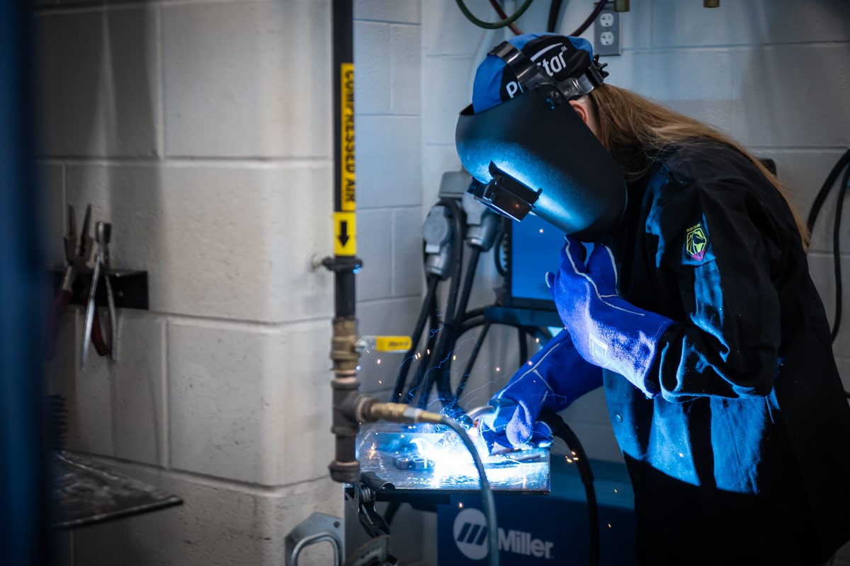 Women in Skilled Trades woman wearing a welding hood while welding