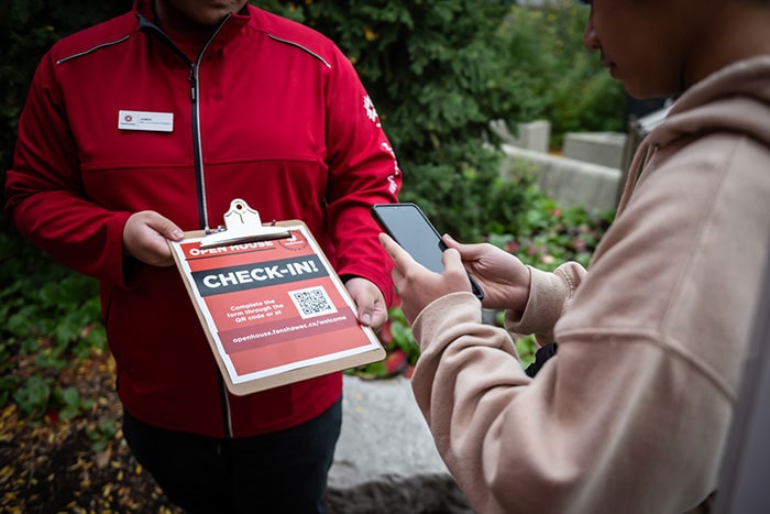 student signs into open house by scanning qr code