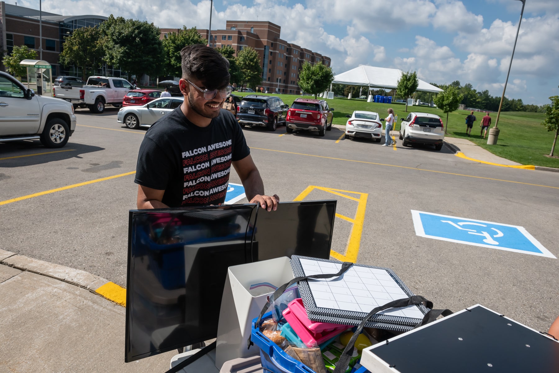 person pushes cart with belongings during move-in day