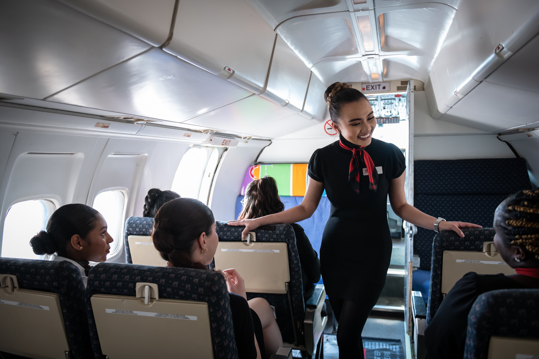Flight Services student talking to airplane passsengers