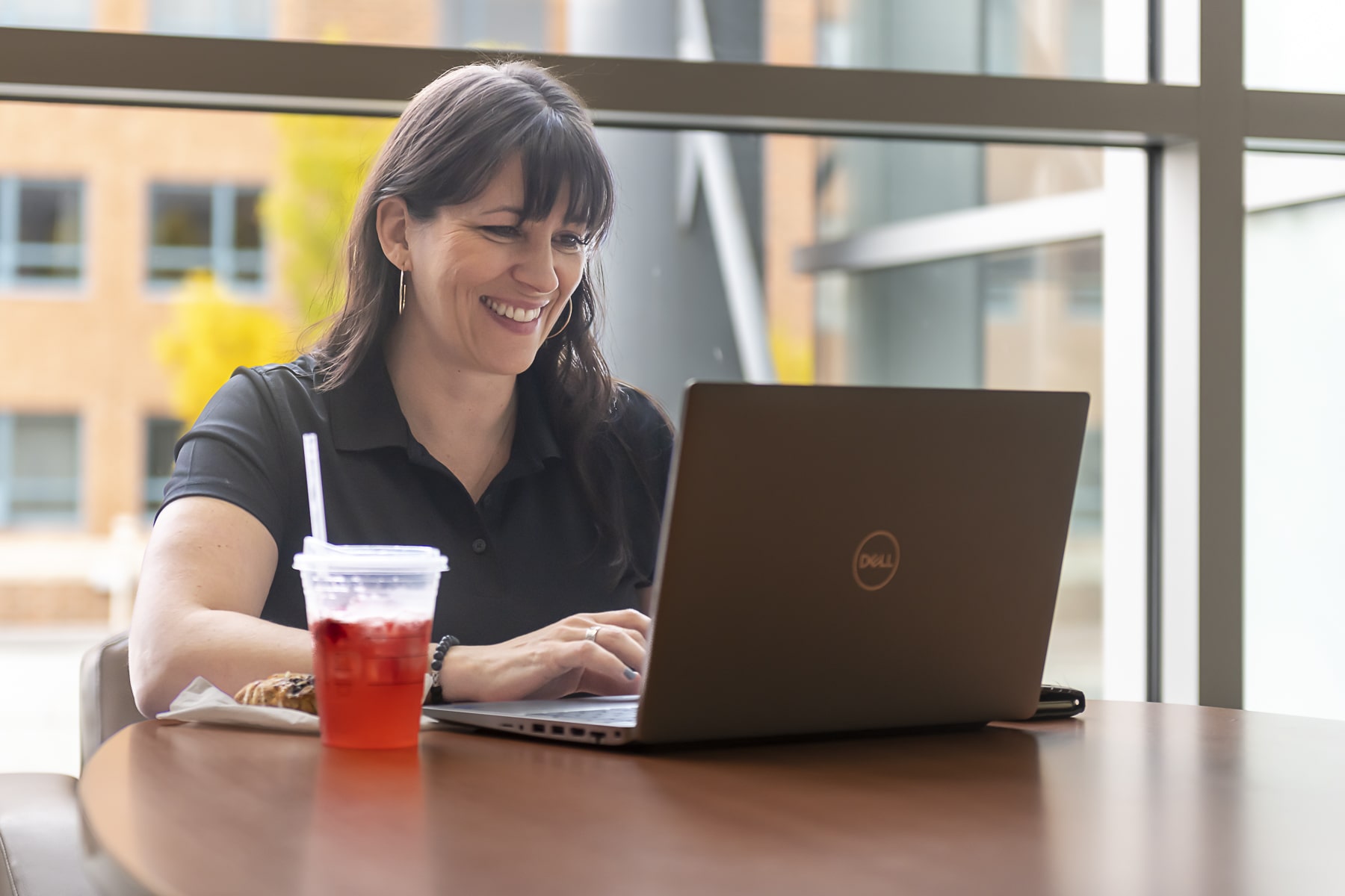 students sits at table with laptop and snacks