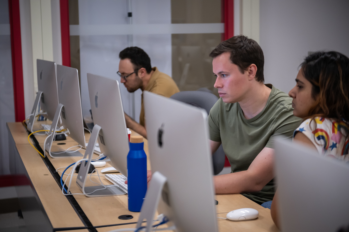 Students looking at a computer in a lab room