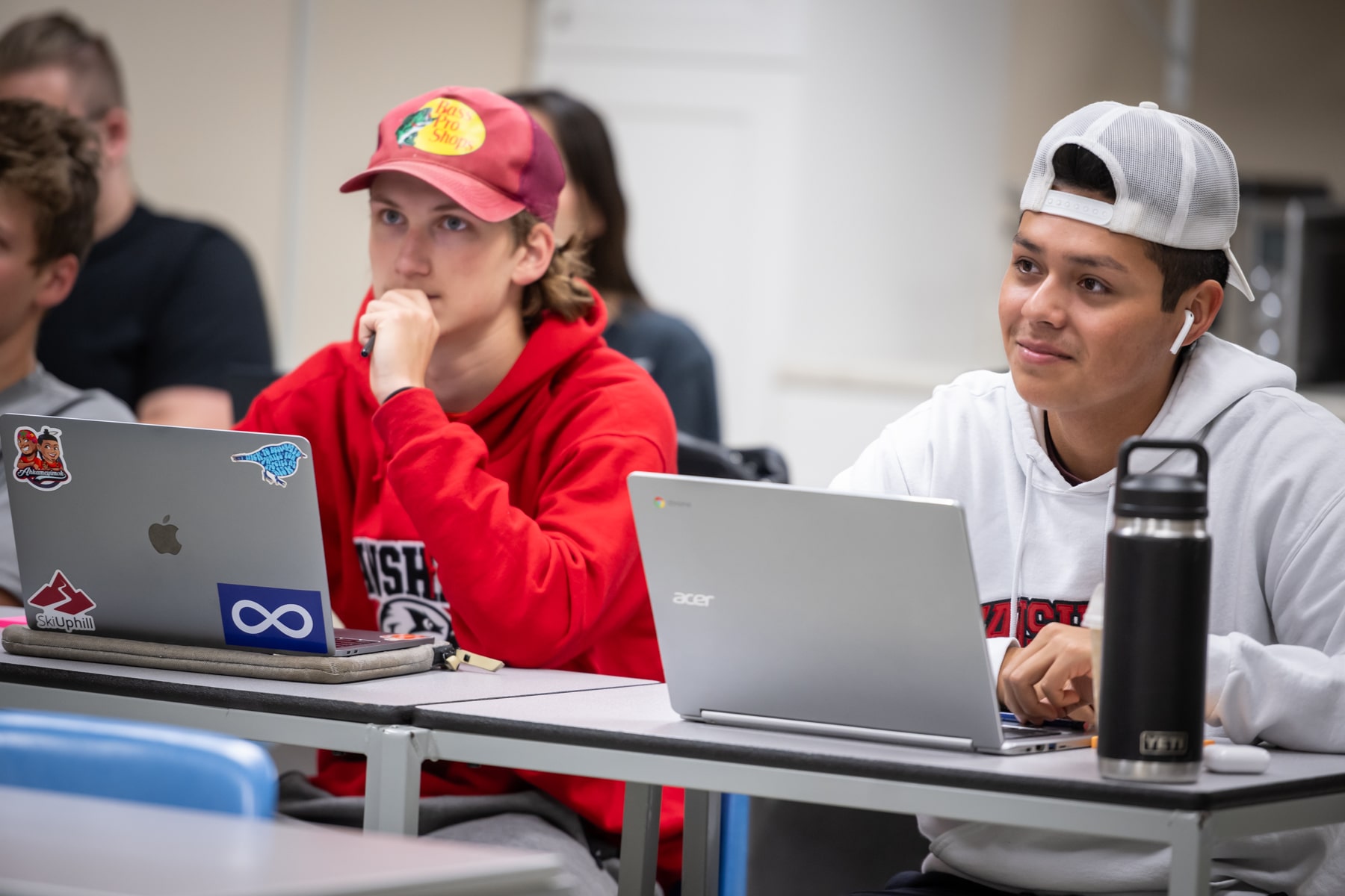 Summer College students sit in a classroom smiling