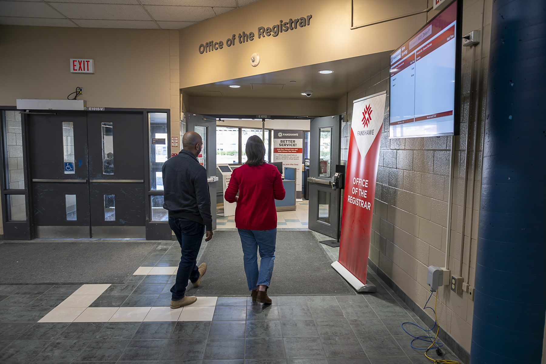 Bursaries as Financial Aid two people walk together into Fanshawe's Office of the Registrar