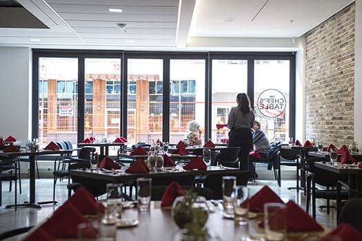 Food and Beverage Servers server talks to customers in a restaurant