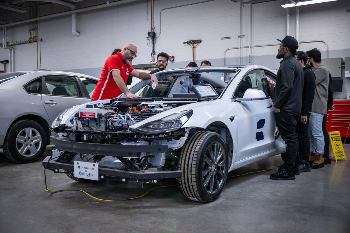 Fanshawe instructor teaching students about the components of an electric vehicle