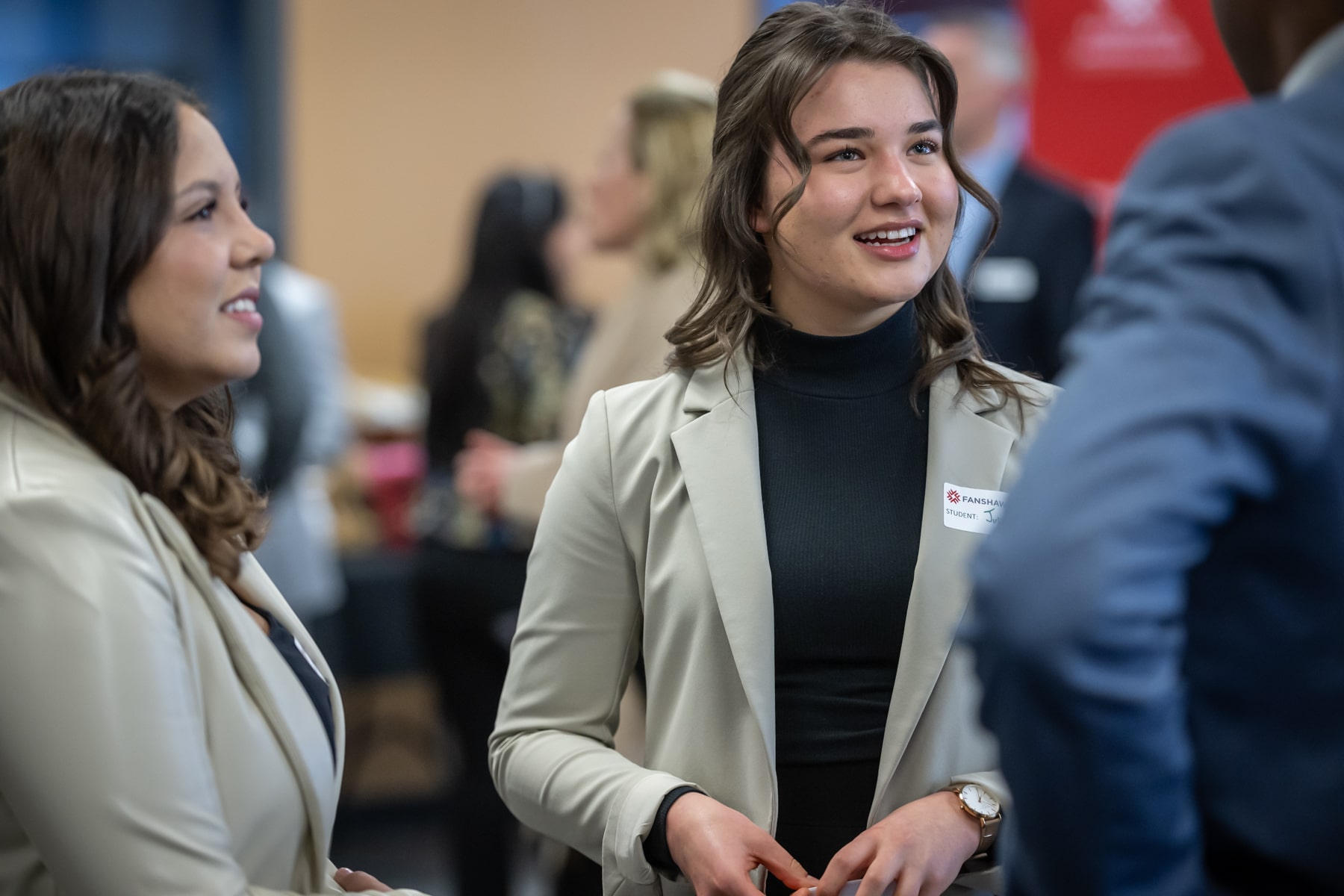 business students chat at networking event