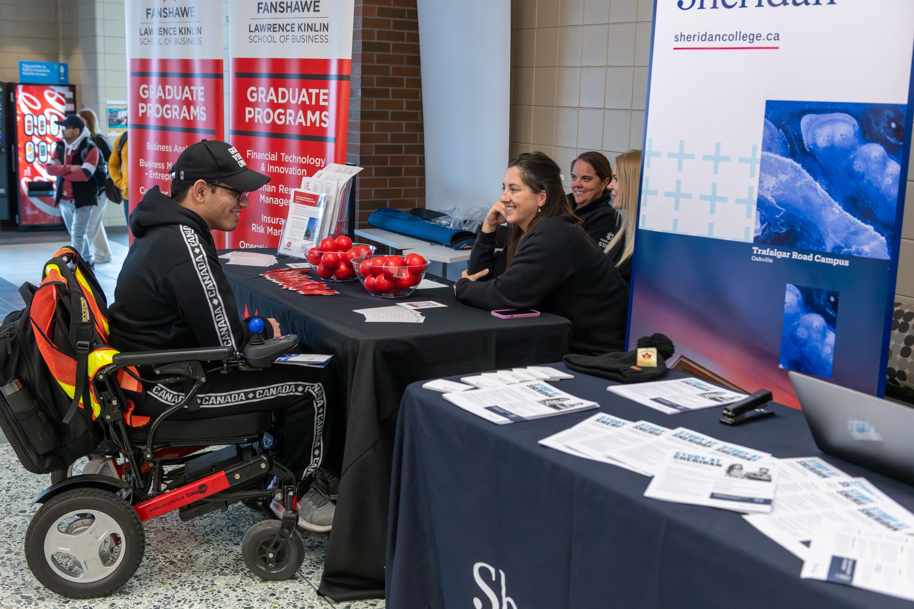 student visits booth at pathways fair