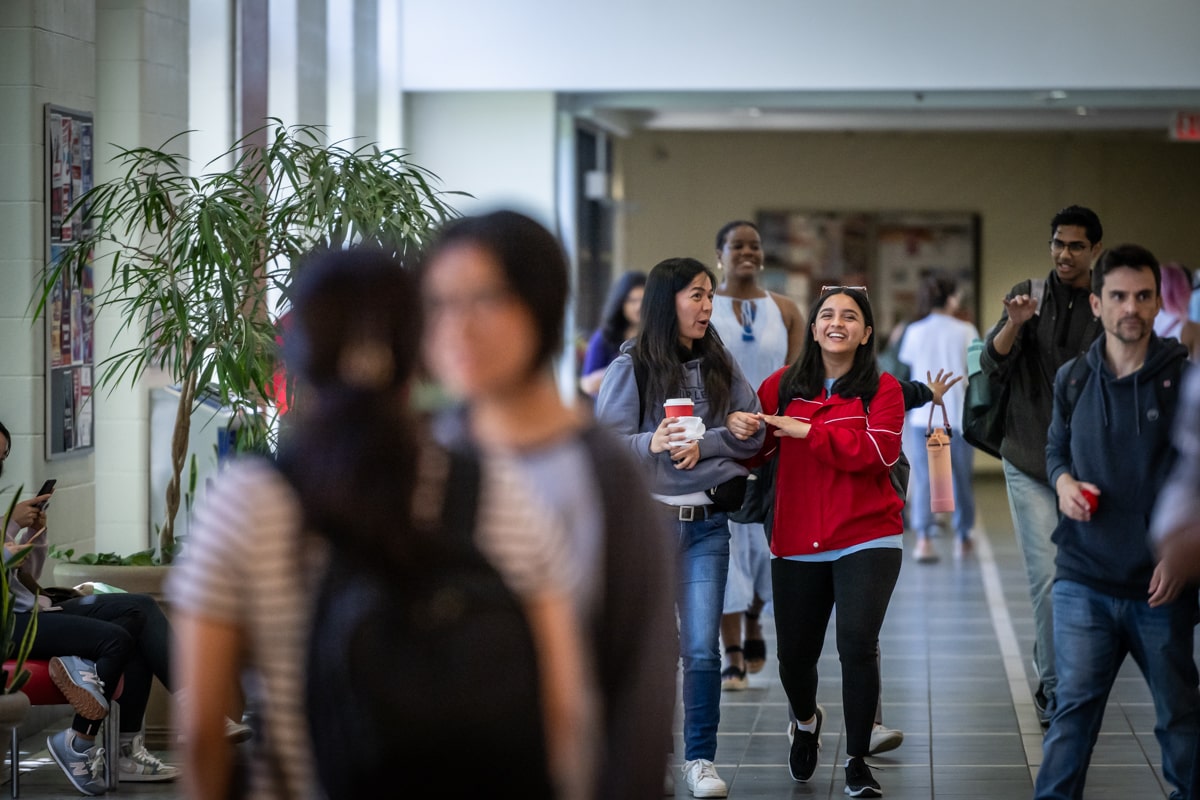 students walk down hallway at Fanshawe