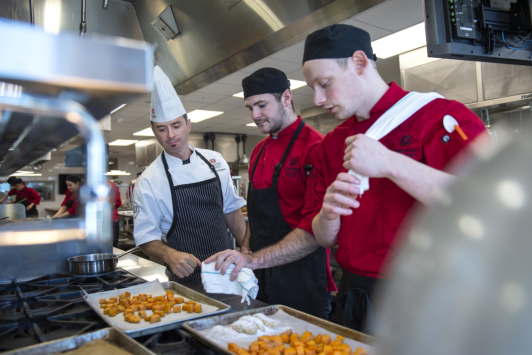 chef provides instruction as students watch