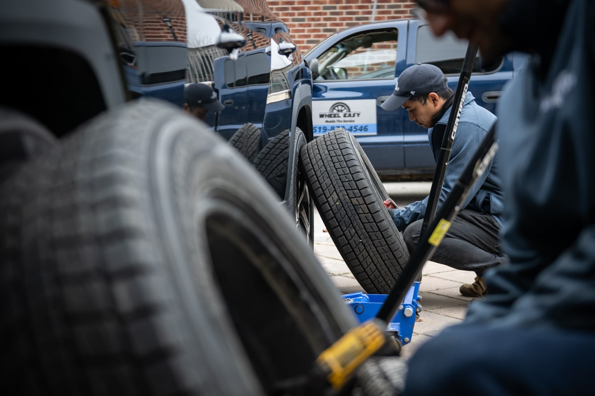 two men are changing tires