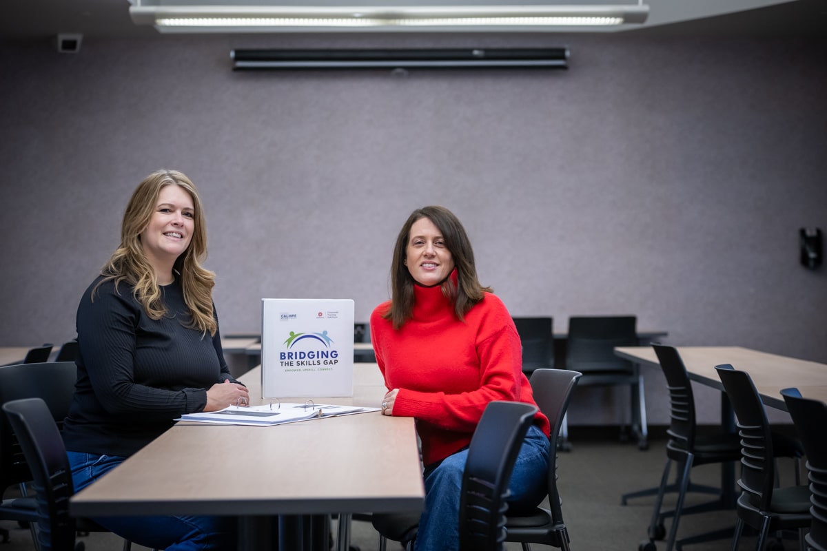 two women are sitting at the table