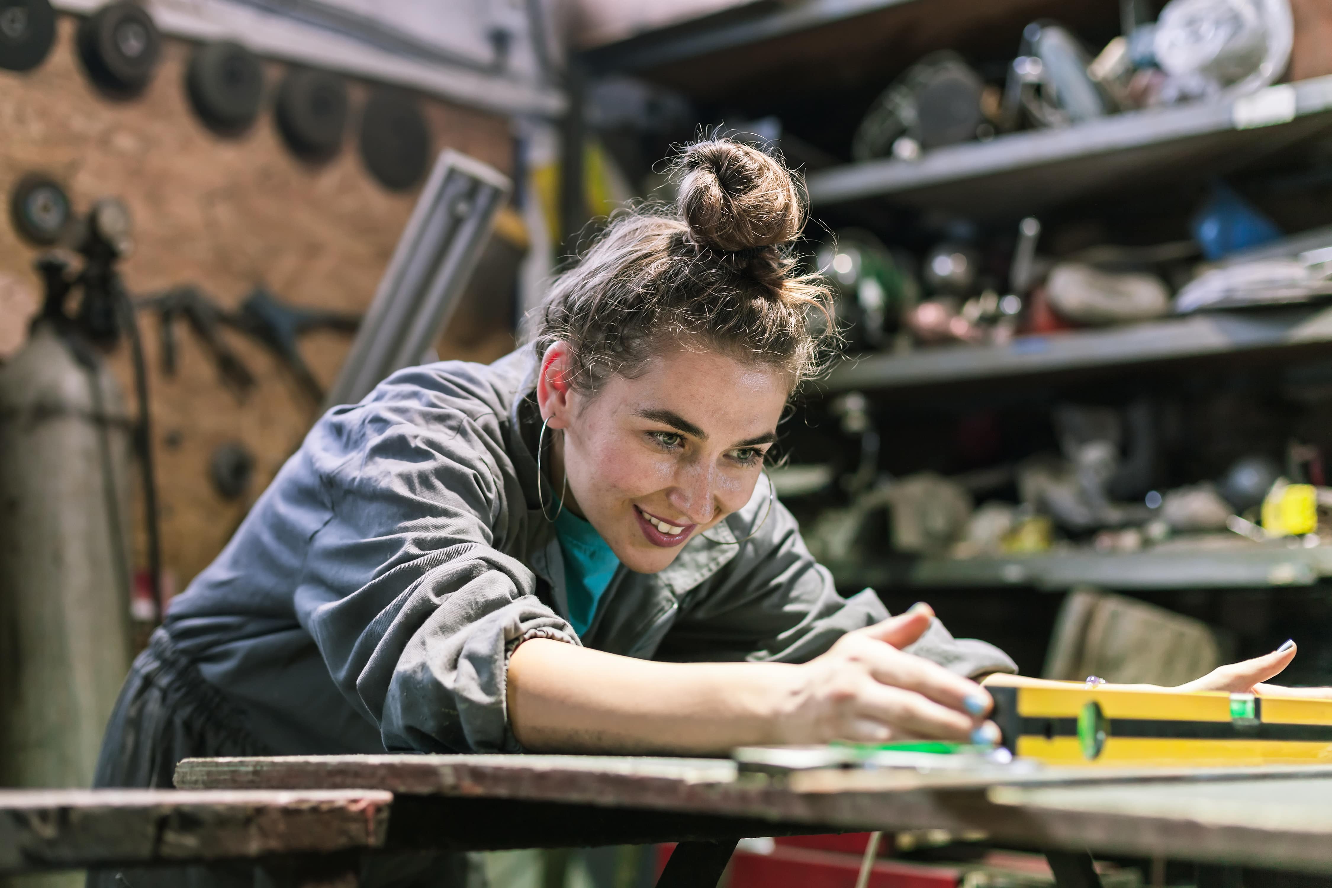 Community for Women in Skilled Trades woman works with level
