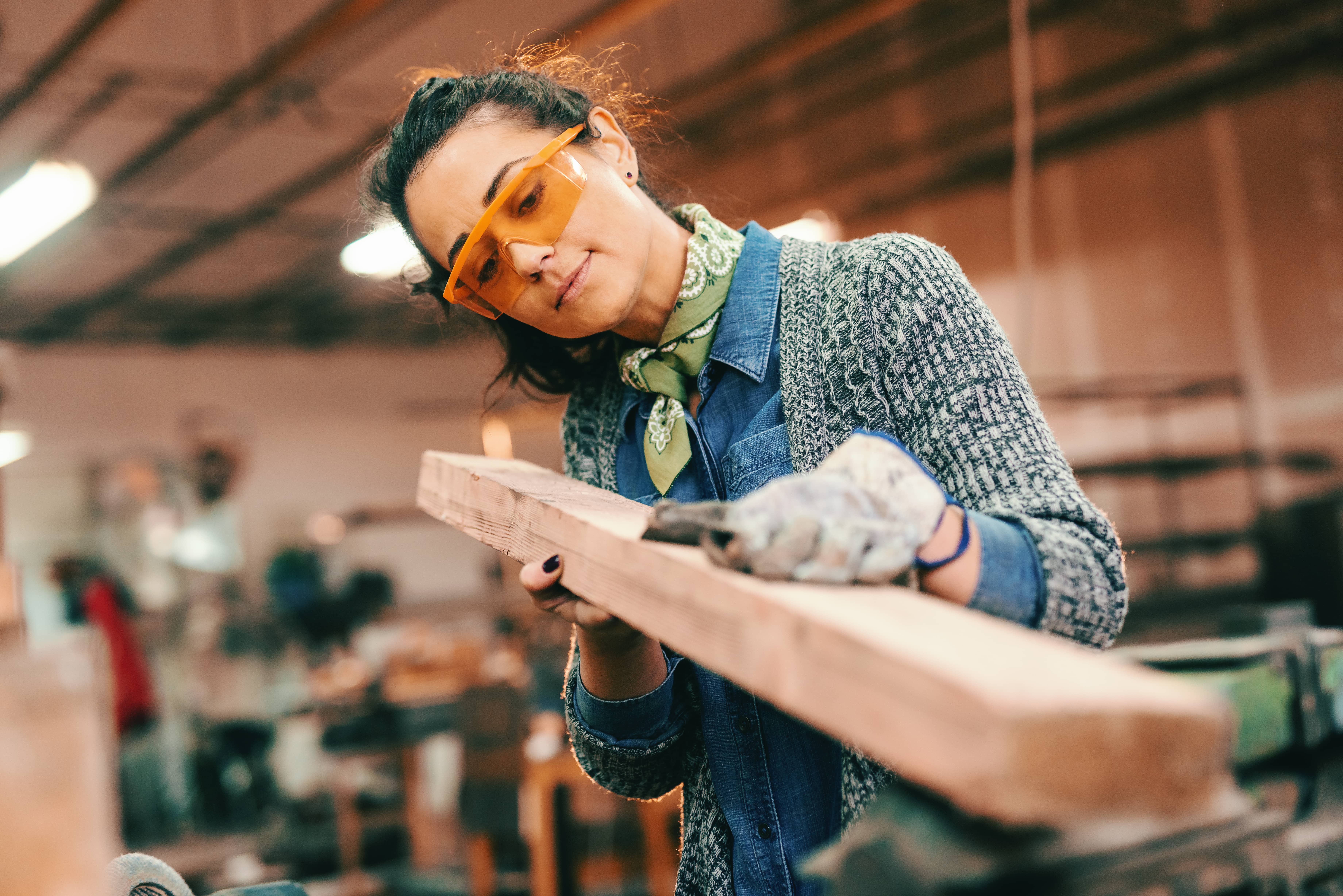 Connect With a Supportive Community woman works with lumber