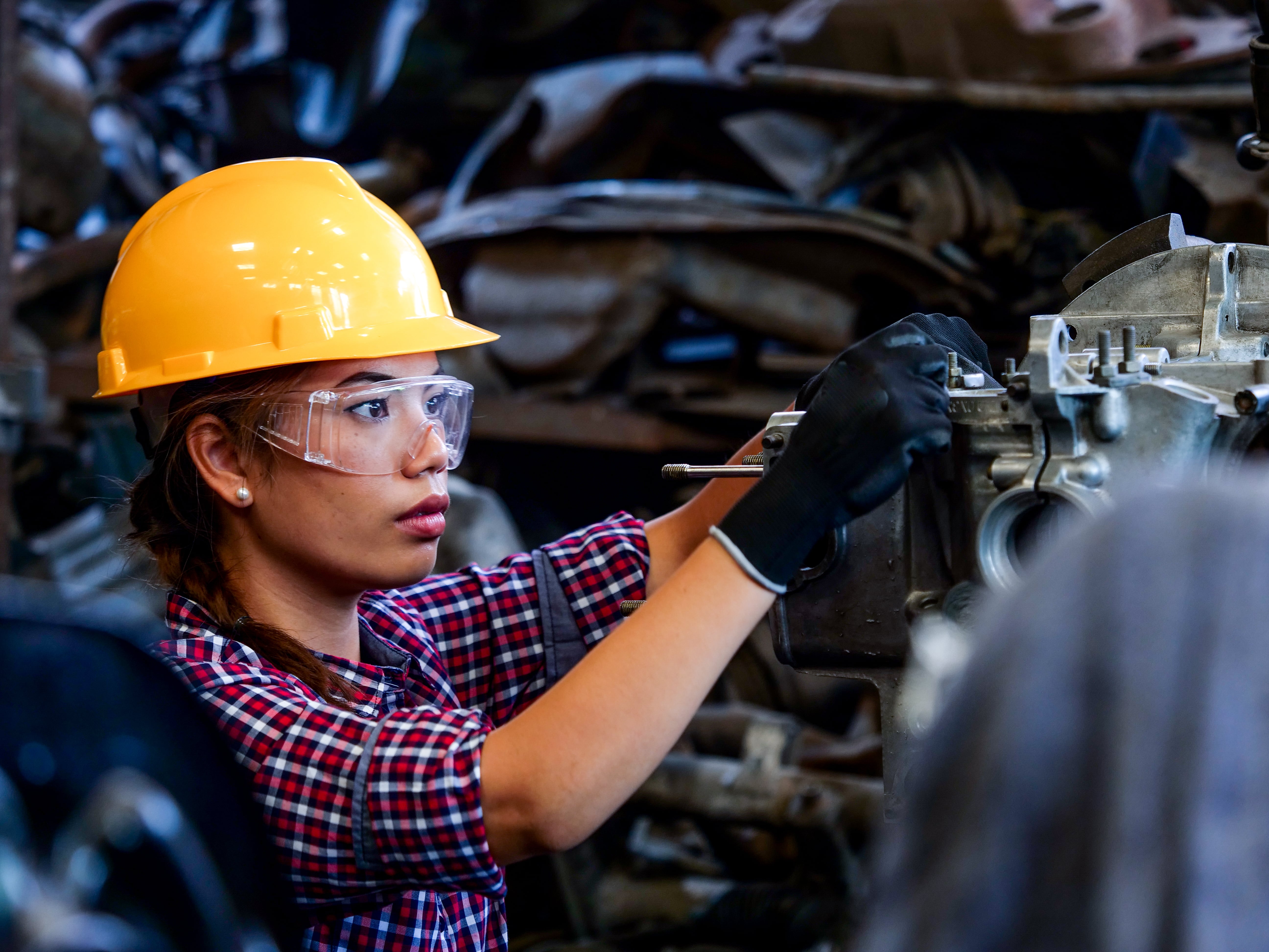 ConnectHer Skilled Trades Community woman works with machinery