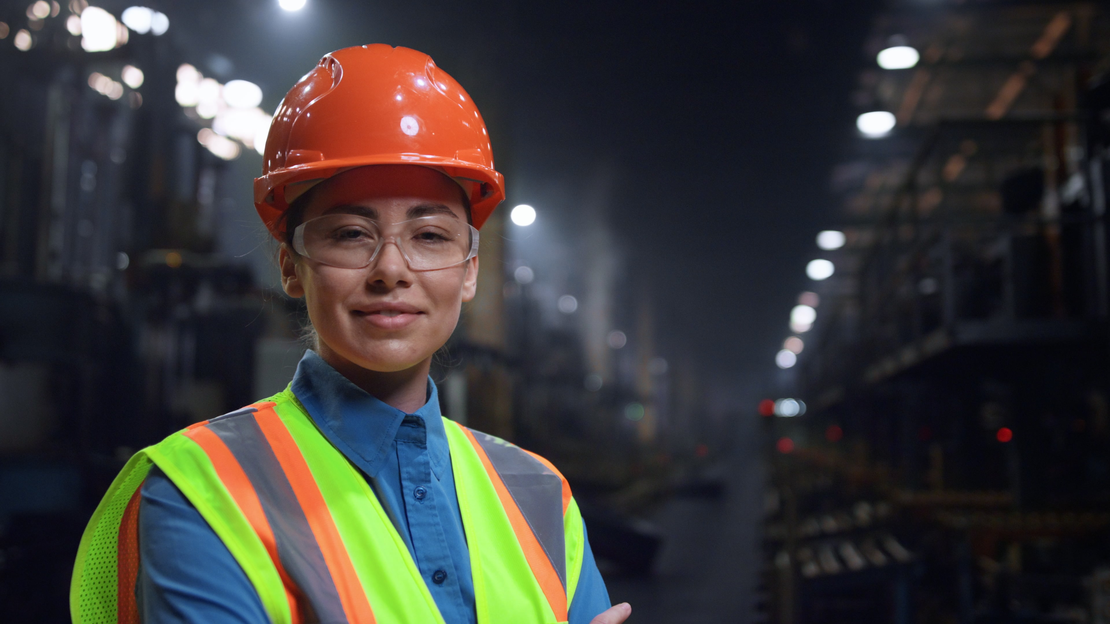 woman in hard had and high viz vest