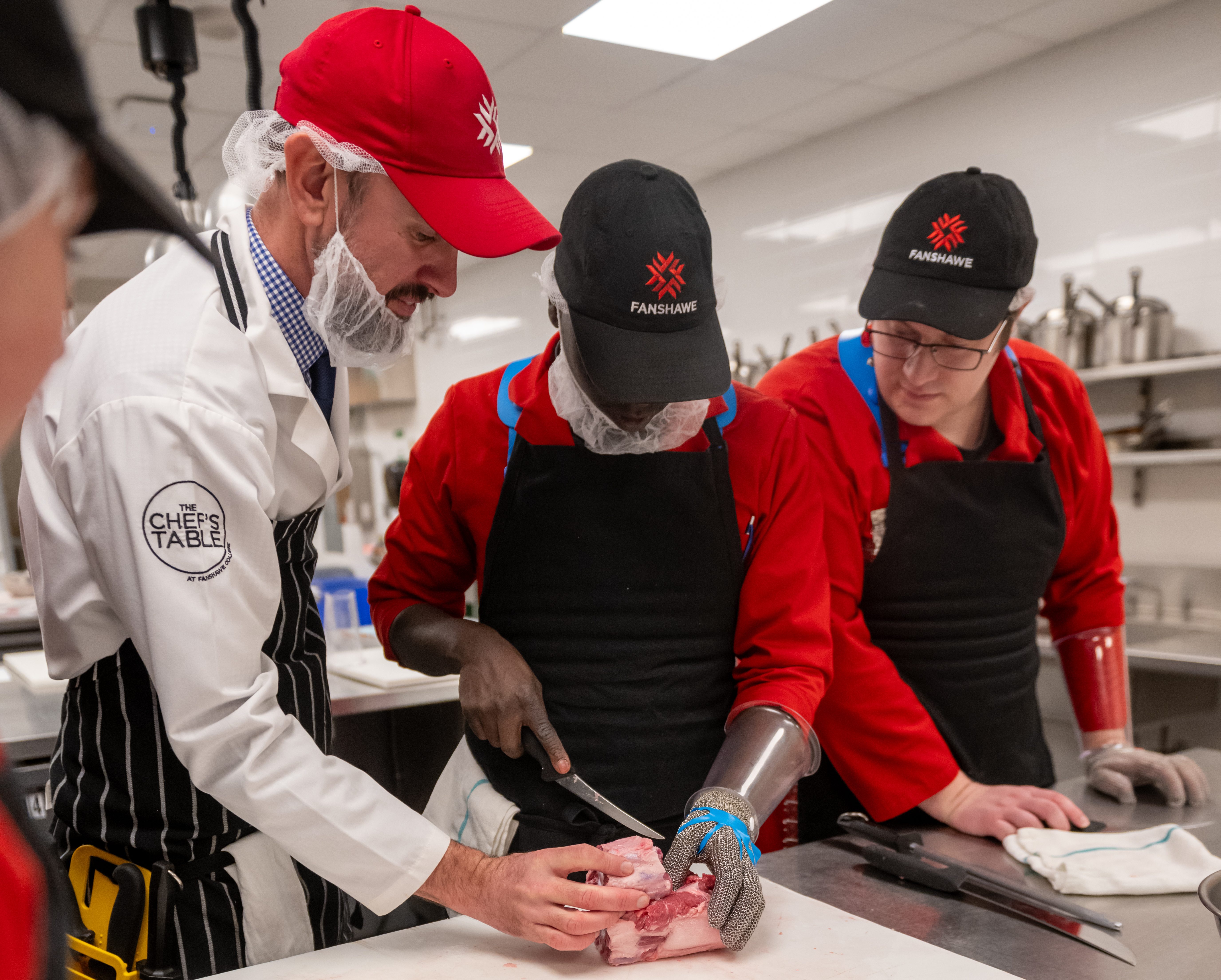Students learning butchery techniques