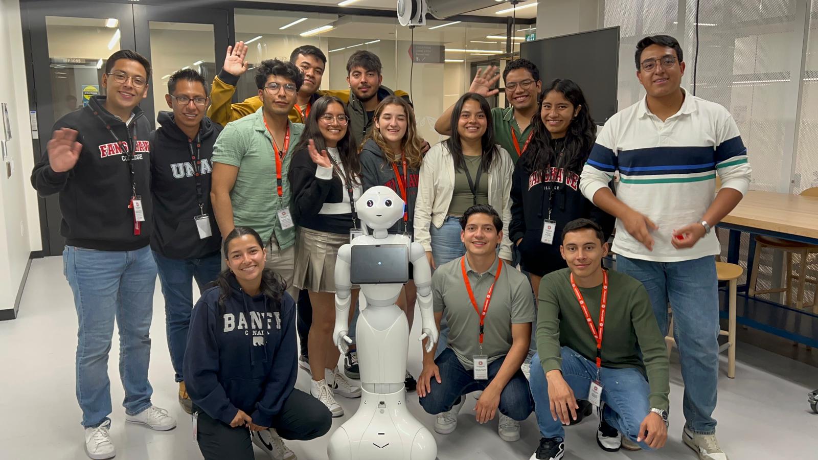 A group of student is taking a photo with a robot