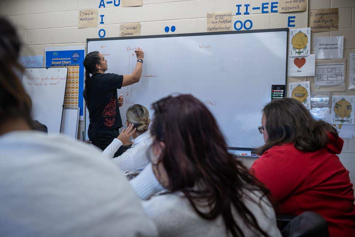 instructor writes on whiteboard in Indigenous Language Program