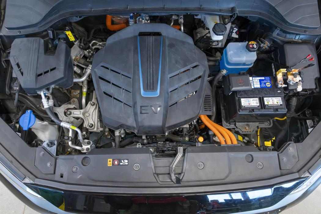 the battery and engine under the hood of an electric vehicle
