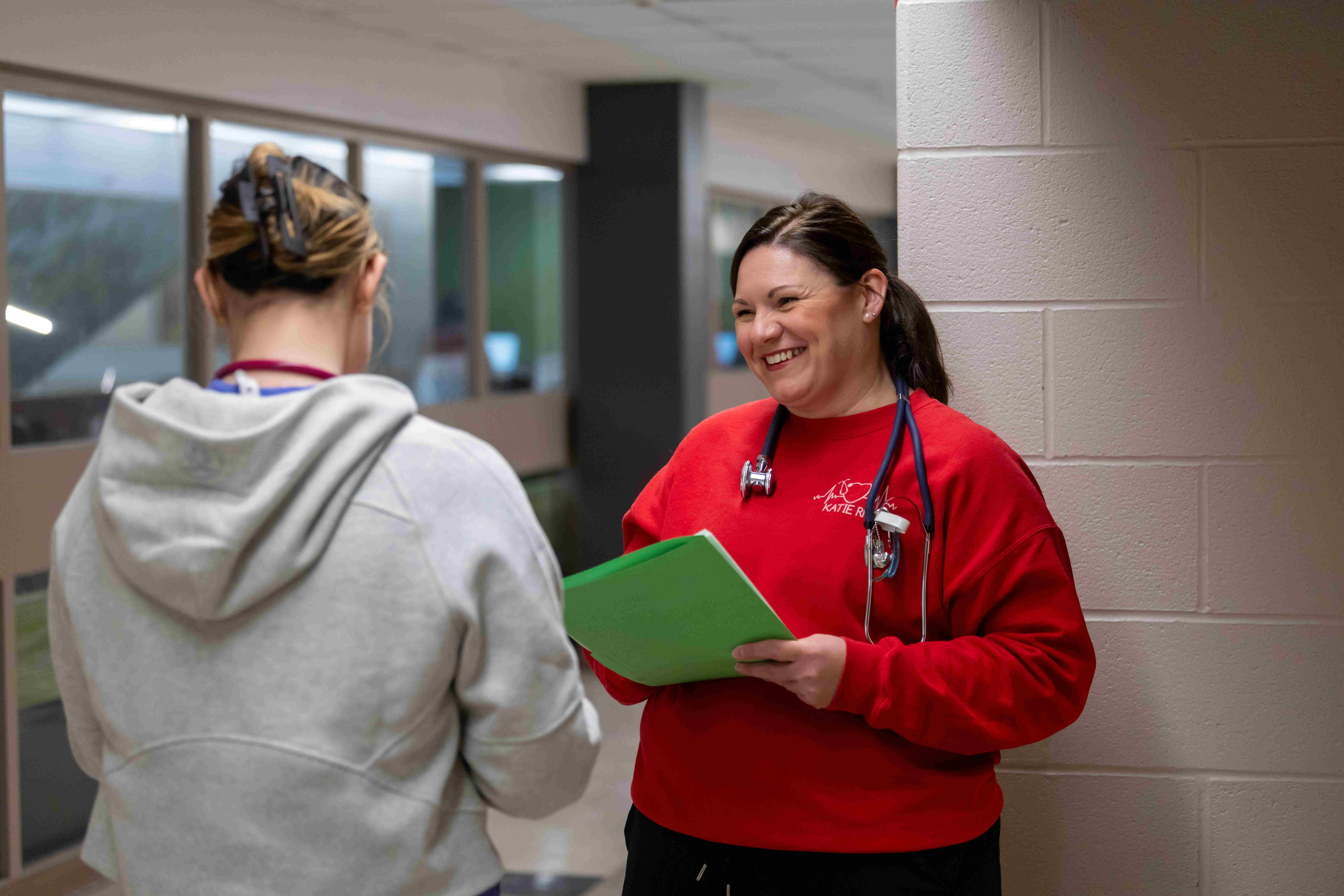 Registered Nurse speaking to another nursing promoting mental health in healthcare
