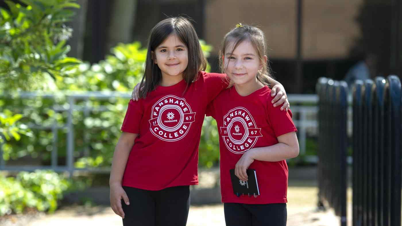 Kids at Junior Falcons Summer Camp two kids stand side by side with arms around each other at summer camp