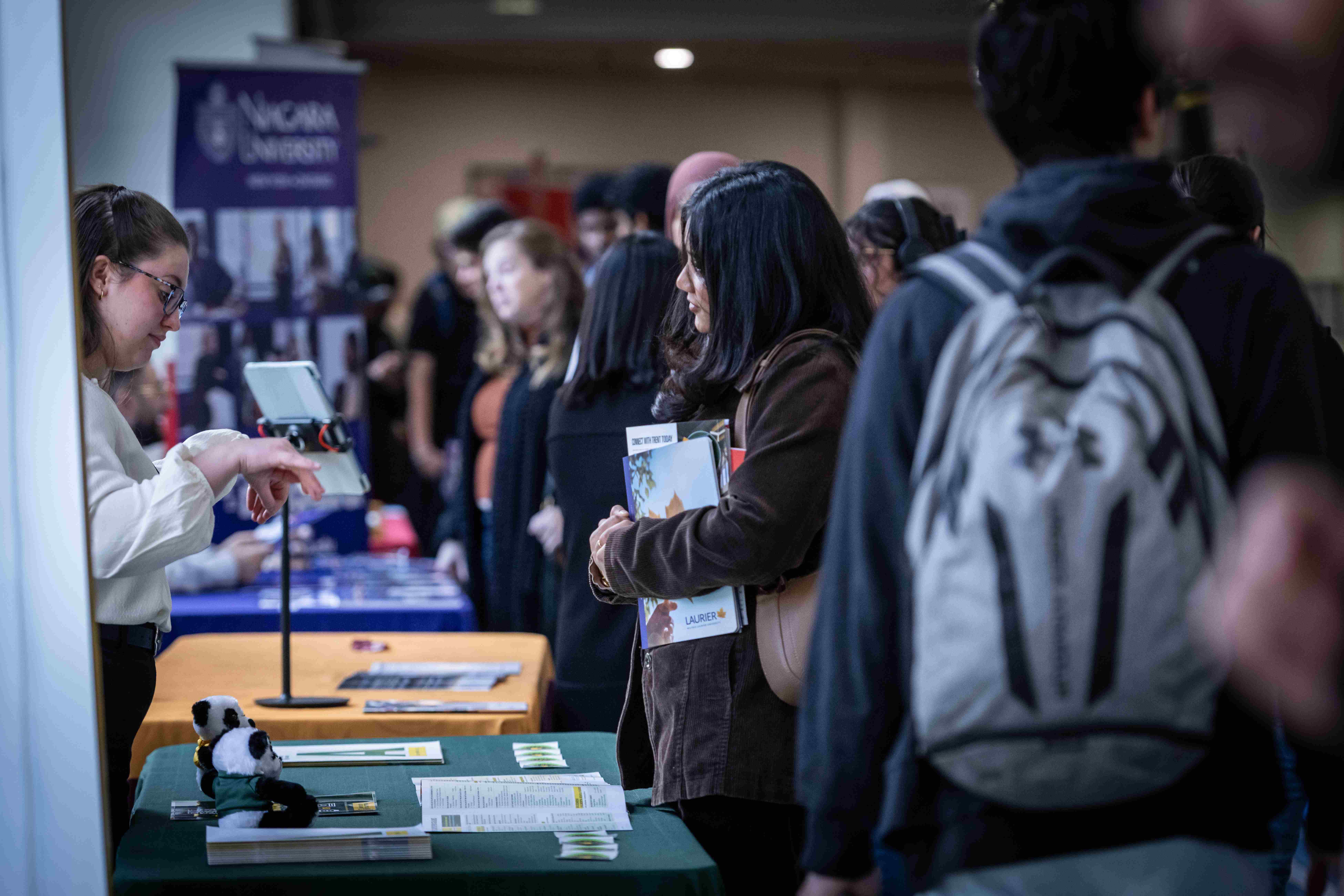 A Fanshawe student interacting with a booth at the pathways fair