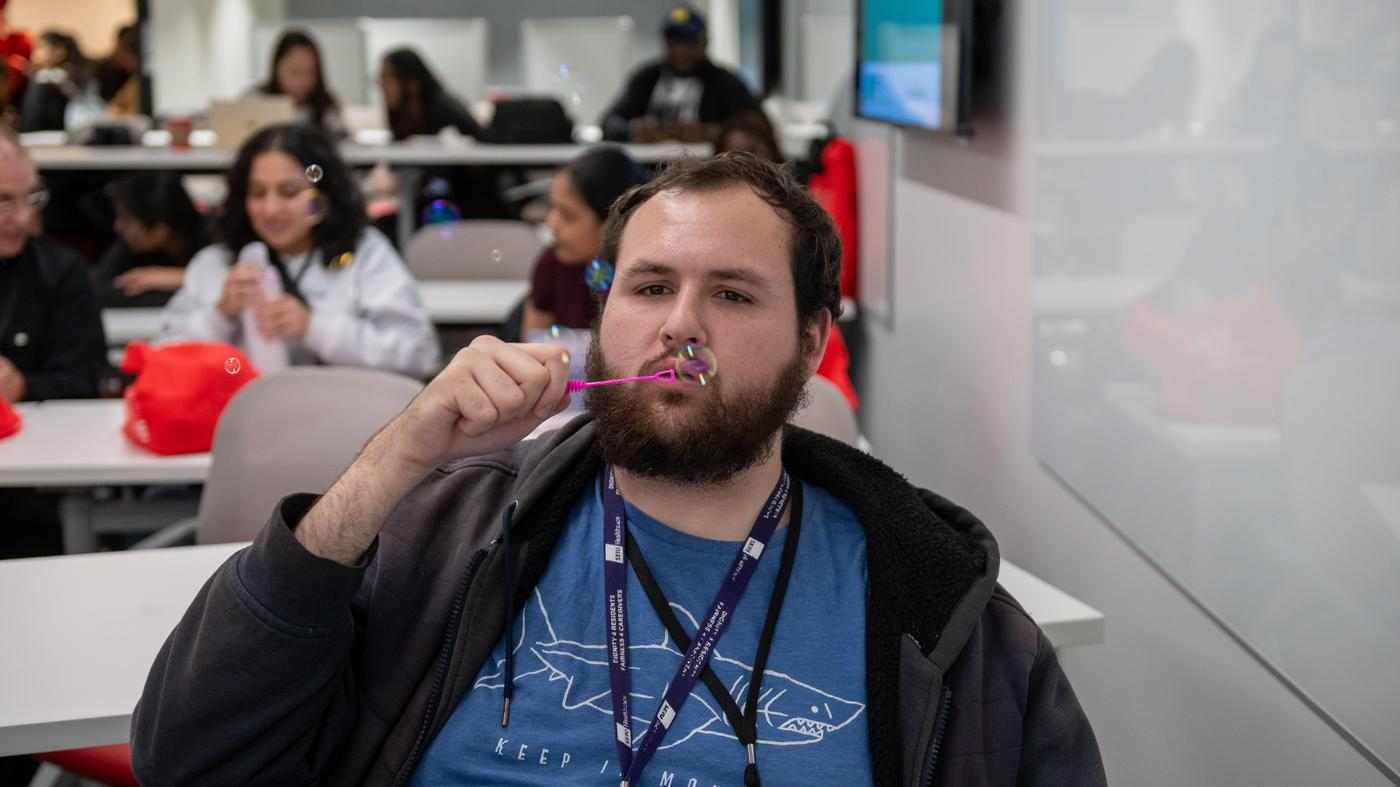 students blow bubbles at self-care conference