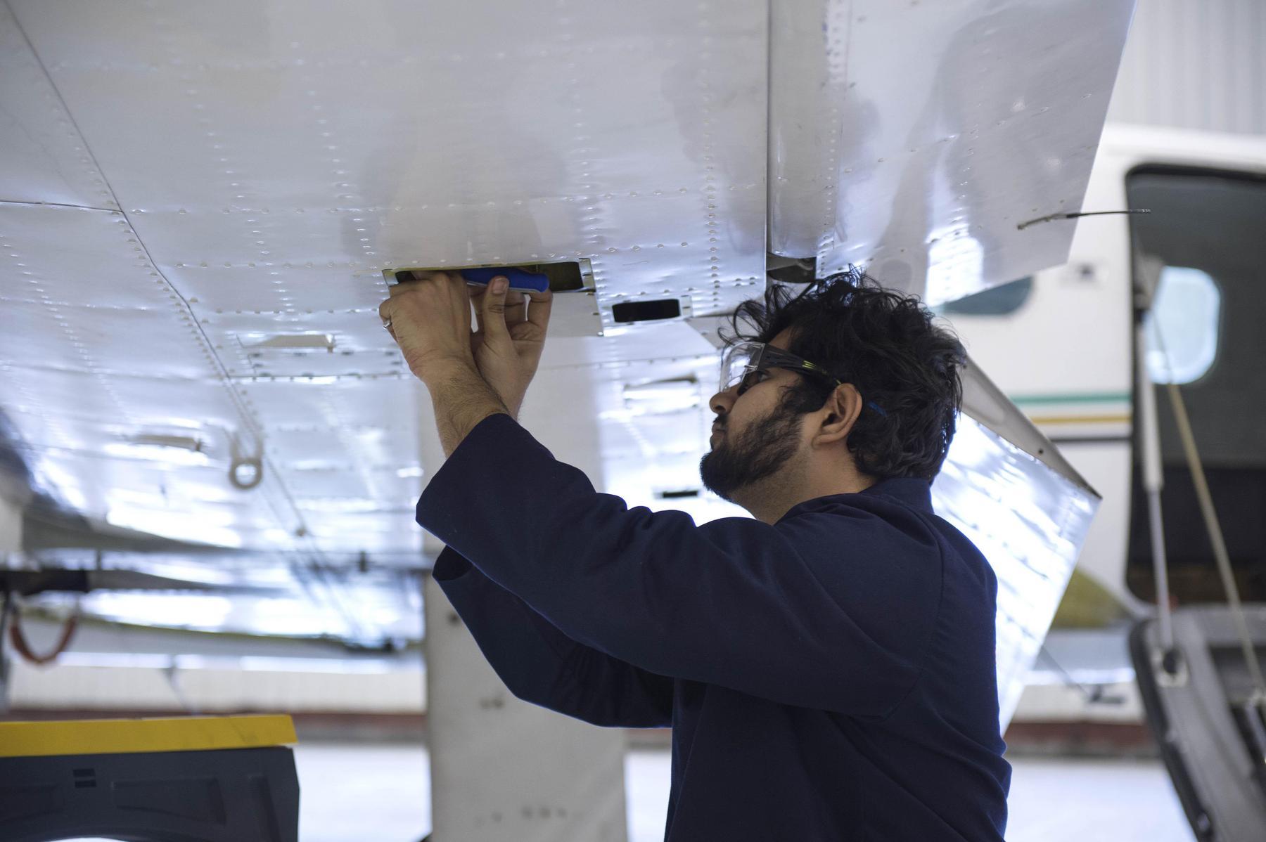 School of Norton student working on the wing of an airplane