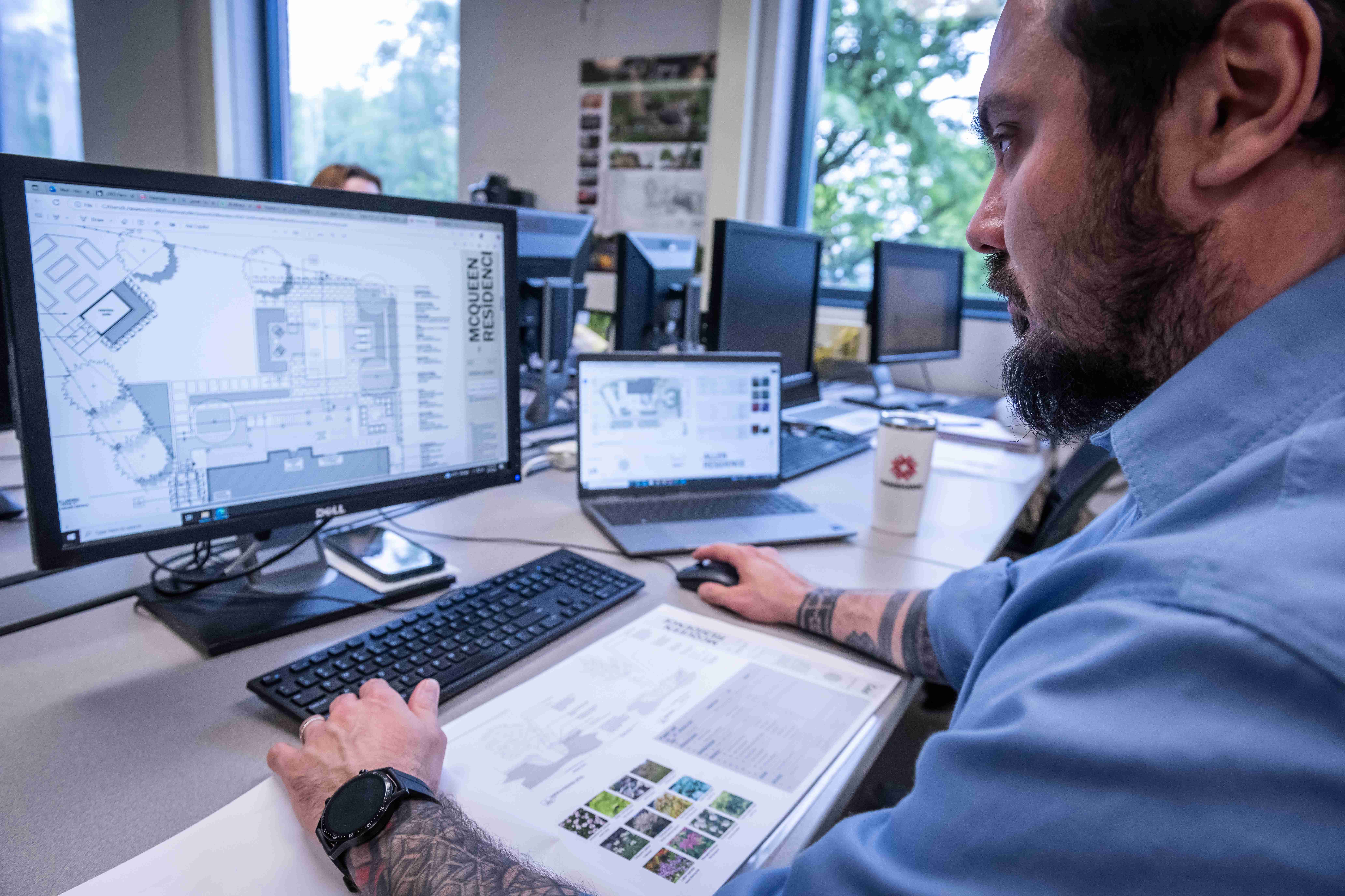 Photo of a student working on a computer rendering of a landscape design