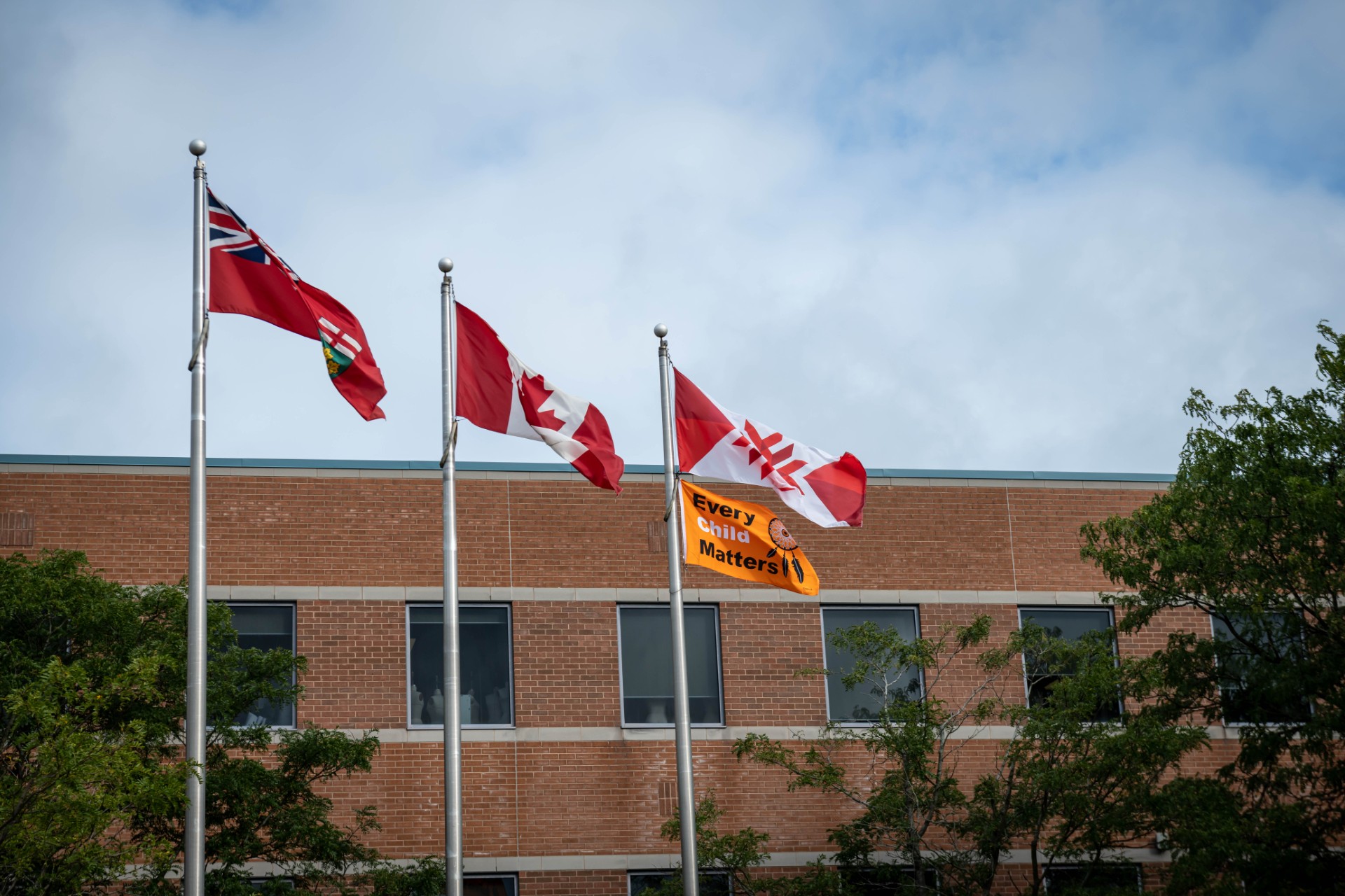 Provincial, Canadian, Fanshawe and Every Child Matters flags