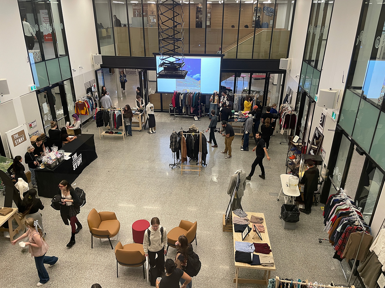 Birds eye view of the Canada Life Village Square room of booths and students in a room