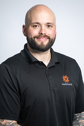Photo of Aaron Peterzon posing for a photo in a black Fanshawe polo