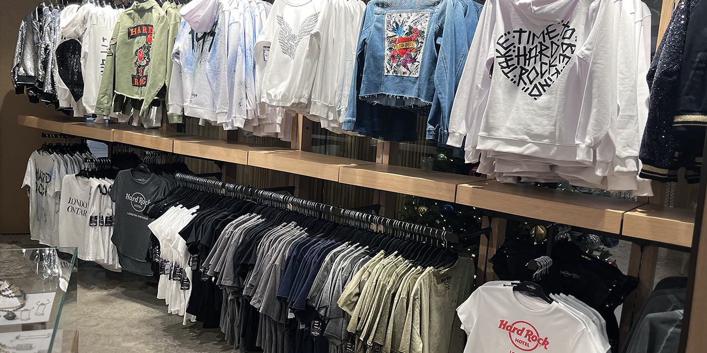 Rows of clothing hanging on a display in the Hard Rock Hotel Rock Shop