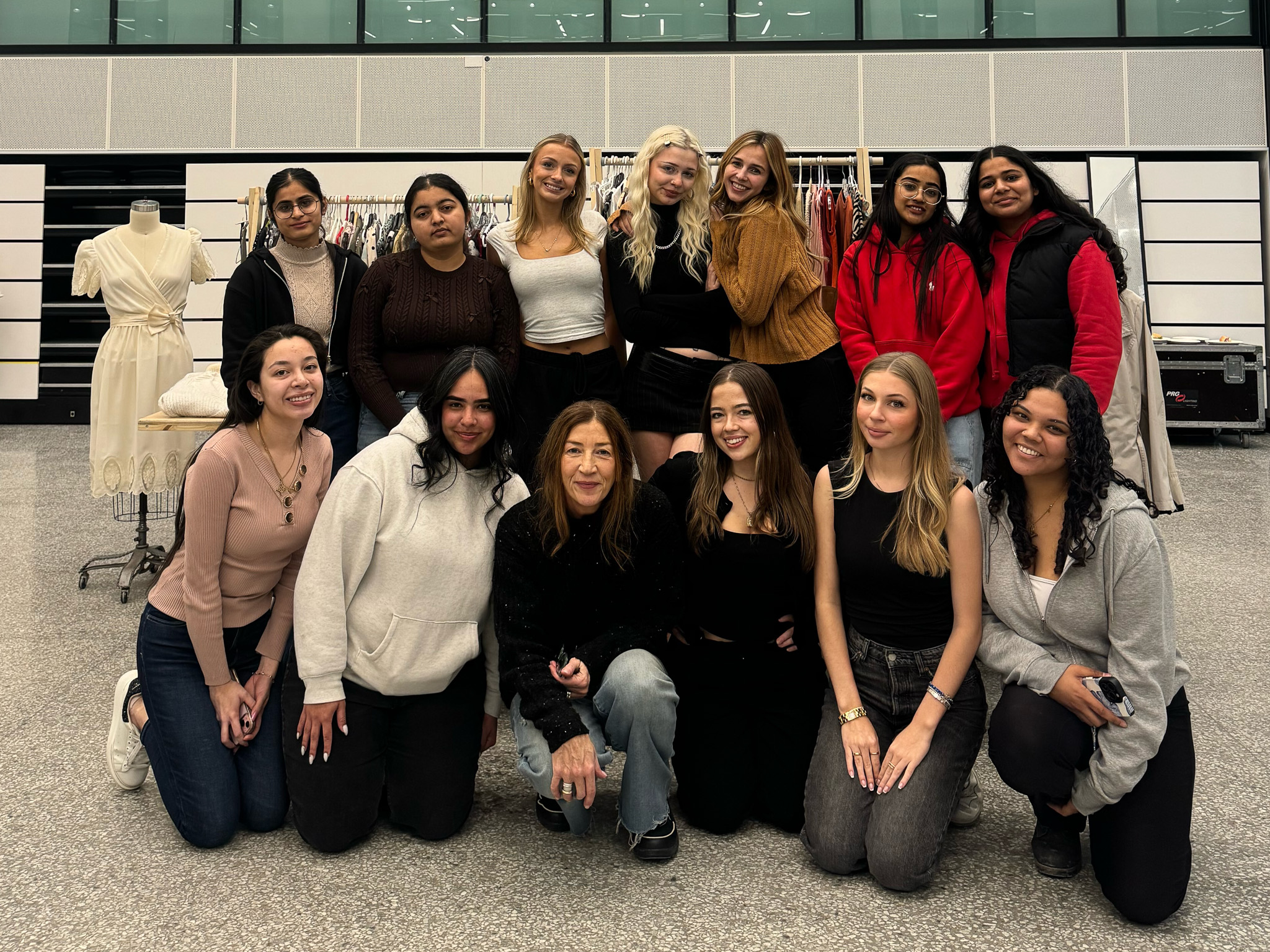 A group of smiling students poses for the camera.